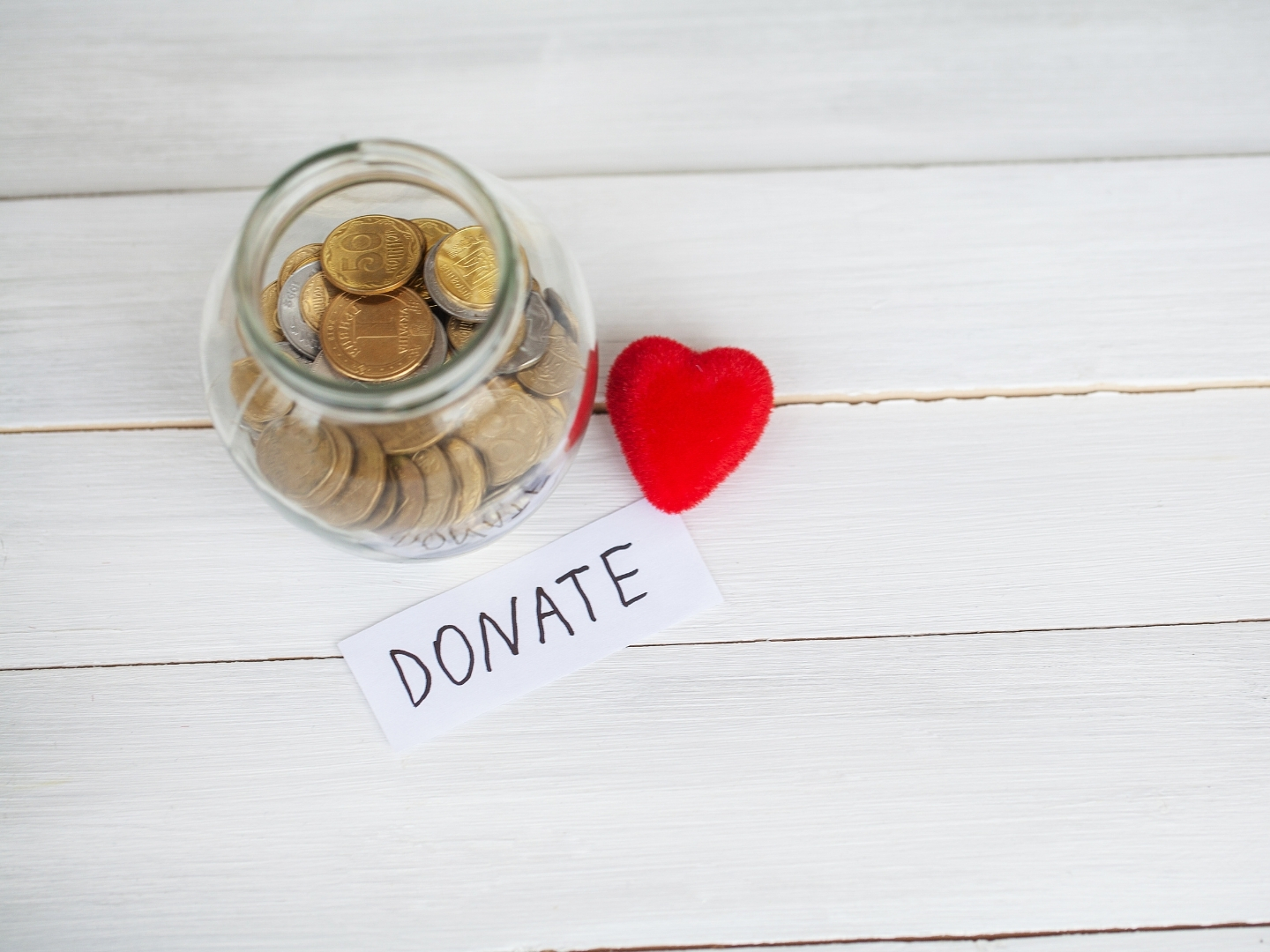 Donation jar and heart symbol representing support for a local community campaign.