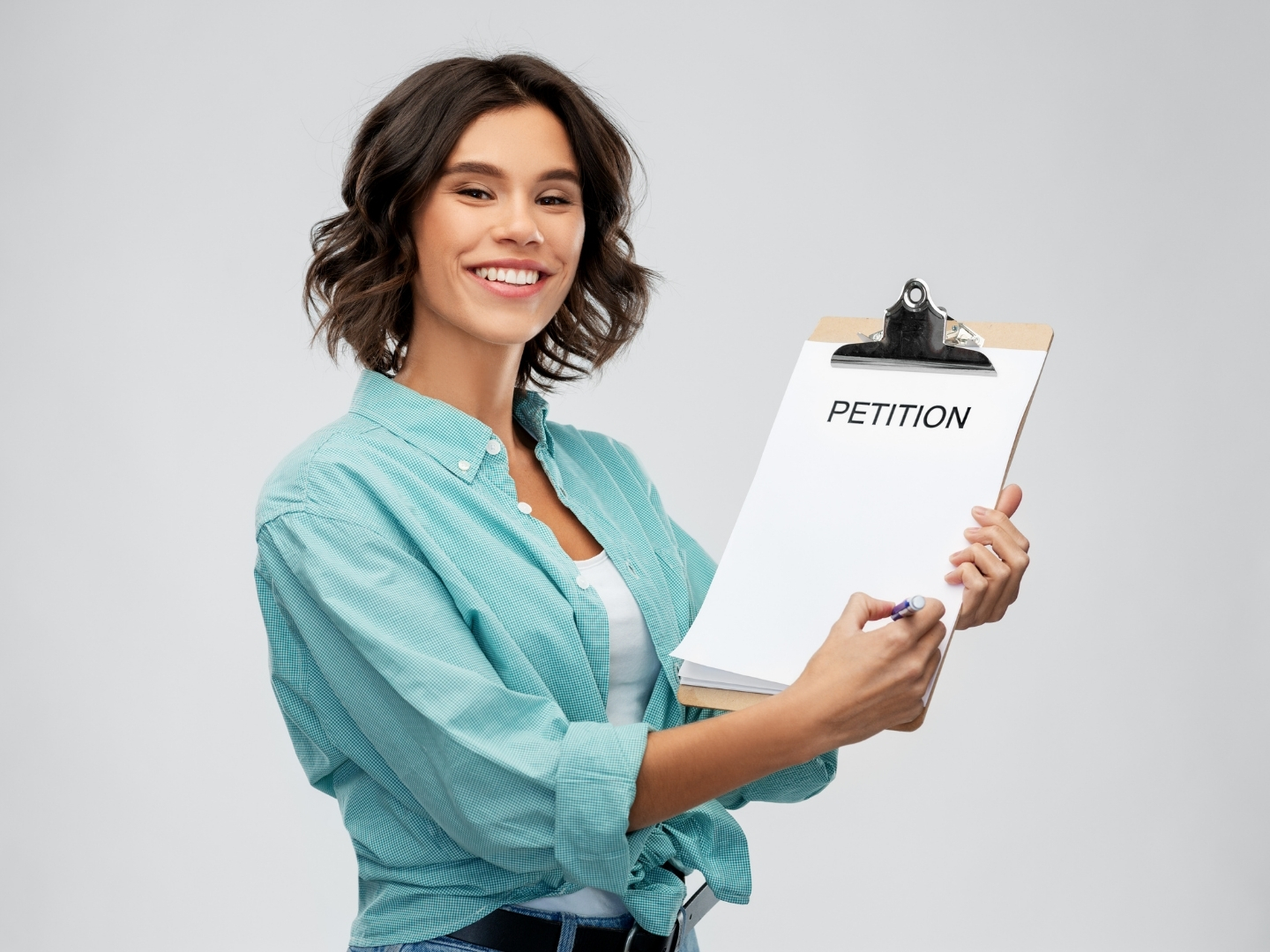 Person holding a petition clipboard encouraging support for a community campaign.
