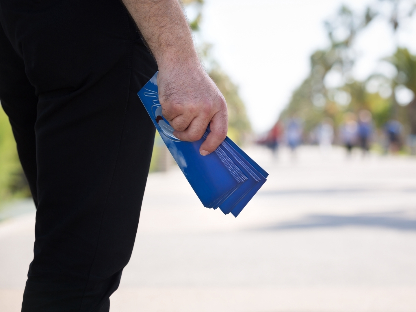 Volunteer carrying campaign leaflets ready to help raise awareness in the local community.