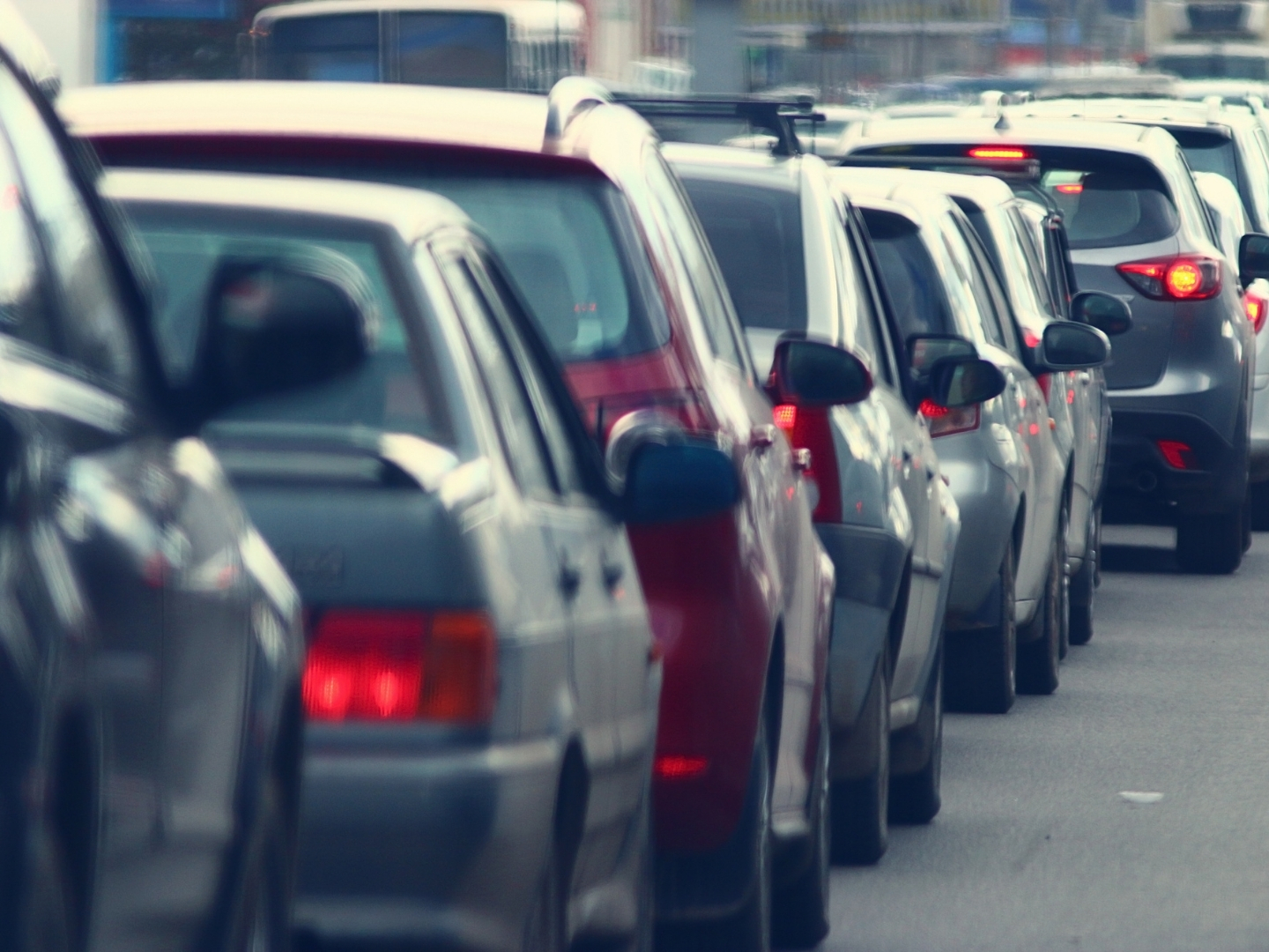 Queue of traffic on a busy road approaching a town.