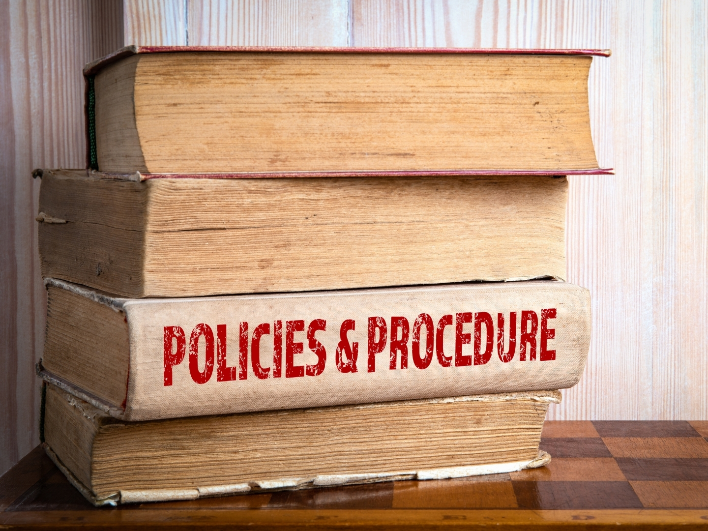Stack of books labelled "Policies and Procedures" representing planning policy and planning guidance.